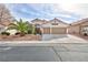 Charming single-story home featuring a two-car garage and desert landscaping with palm tree at 3957 Genoa Dr, Las Vegas, NV 89141