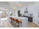 Bright kitchen with quartz countertops, stainless appliances, and large island overlooking the pool through sliding glass doors at 3957 Genoa Dr, Las Vegas, NV 89141