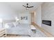 Bright main bedroom with a modern fireplace, ceiling fan, and light wood flooring at 3957 Genoa Dr, Las Vegas, NV 89141