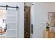 Sleek wine cellar with glass door and wooden rack system, visible through a modern barn door at 3957 Genoa Dr, Las Vegas, NV 89141