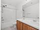 Bright bathroom featuring a double sink vanity, a large mirror, and a shower-tub combination at 430 Shimmering Sands Ave, North Las Vegas, NV 89031