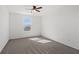 Well-lit bedroom featuring neutral carpeting and an expansive window, creating an inviting space at 430 Shimmering Sands Ave, North Las Vegas, NV 89031