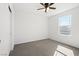 Bright bedroom featuring soft carpeting, natural light from a window, and a closet for storage at 430 Shimmering Sands Ave, North Las Vegas, NV 89031