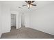 Inviting bedroom showcasing a ceiling fan, plush carpeting, and multiple doorways for easy access at 430 Shimmering Sands Ave, North Las Vegas, NV 89031