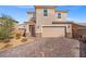 Charming two-story home with desert landscaping and a brick driveway at 430 Shimmering Sands Ave, North Las Vegas, NV 89031