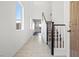 Bright entryway with staircase and tile flooring, offering a welcoming space at 430 Shimmering Sands Ave, North Las Vegas, NV 89031