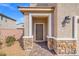 Inviting front entrance with stone accents and covered porch at 430 Shimmering Sands Ave, North Las Vegas, NV 89031