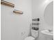 Stylish half bathroom with floating shelves, modern fixtures, and a sleek design at 430 Shimmering Sands Ave, North Las Vegas, NV 89031
