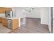 Open kitchen with stainless appliances, island with seating, and views of the living room at 430 Shimmering Sands Ave, North Las Vegas, NV 89031