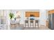 Bright eat-in kitchen features a center island, stainless appliances, and bar seating at 430 Shimmering Sands Ave, North Las Vegas, NV 89031