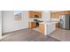 Kitchen with stainless appliances, island, and view of backyard at 430 Shimmering Sands Ave, North Las Vegas, NV 89031