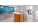 A view of the kitchen island, featuring a double sink, and stainless steel dishwasher, with modern finishes at 430 Shimmering Sands Ave, North Las Vegas, NV 89031