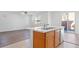 Open kitchen with an island featuring wooden cabinets, a sink, and a dishwasher at 430 Shimmering Sands Ave, North Las Vegas, NV 89031