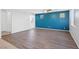 Spacious living room featuring modern wood flooring and an accent wall for contemporary design at 430 Shimmering Sands Ave, North Las Vegas, NV 89031