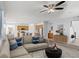 Bright, open living room with modern furnishings, a ceiling fan, and stylish decor at 430 Shimmering Sands Ave, North Las Vegas, NV 89031