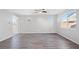 Bright, open living room with wood flooring and large windows for natural light at 430 Shimmering Sands Ave, North Las Vegas, NV 89031