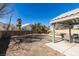 Large backyard with a covered patio, mature trees, rock water feature and block wall at 4421 Rodman Dr, Las Vegas, NV 89130