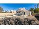 Backyard featuring patio, pool with rock feature, mature trees, and block wall at 4421 Rodman Dr, Las Vegas, NV 89130