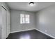 Bedroom with a window, closet, light gray walls, dark wood-look flooring and white trim at 4421 Rodman Dr, Las Vegas, NV 89130