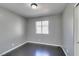 Bedroom featuring gray walls, dark wood-look flooring, a window, and a closet with white doors at 4421 Rodman Dr, Las Vegas, NV 89130