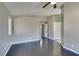 Bedroom featuring gray walls, dark wood-look floors, multiple doors, and a window at 4421 Rodman Dr, Las Vegas, NV 89130