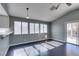 Bright living room features three large windows providing ample natural lighting and a neutral color scheme at 4421 Rodman Dr, Las Vegas, NV 89130