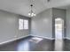 Comfortable living room features dark hardwood floors, a chandelier, and a window at 4421 Rodman Dr, Las Vegas, NV 89130