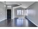 Cozy living room with hardwood floors, neutral paint, and a black front door at 4421 Rodman Dr, Las Vegas, NV 89130