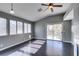 Bright living room with dark wood floors, fan, and sliding glass doors to outdoor living at 4421 Rodman Dr, Las Vegas, NV 89130