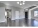 Open floor plan living room leads to hallway, with hardwood floors and ample light at 4421 Rodman Dr, Las Vegas, NV 89130