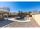 Backyard view of pool with rock features, patio area, and desert landscaping at 4421 Rodman Dr, Las Vegas, NV 89130