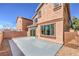 Exterior view of the house with a slider to the concrete patio and low maintenance yard at 4473 Oberlander Ave, North Las Vegas, NV 89031