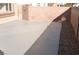 A concrete backyard with gray paint and a brick wall at 4473 Oberlander Ave, North Las Vegas, NV 89031