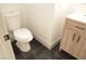 Bathroom features a white toilet and a light wood vanity with black hardware at 4473 Oberlander Ave, North Las Vegas, NV 89031