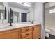 This bathroom includes double sinks, granite countertops, and a glass enclosed shower at 4473 Oberlander Ave, North Las Vegas, NV 89031