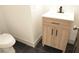 Modern bathroom features a wood vanity with black hardware and black tile flooring at 4473 Oberlander Ave, North Las Vegas, NV 89031