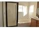 Modern bathroom featuring a tiled shower, soaking tub, and a sleek vanity at 4473 Oberlander Ave, North Las Vegas, NV 89031