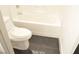 Clean bathroom featuring a toilet, bathtub, and black tile flooring at 4473 Oberlander Ave, North Las Vegas, NV 89031