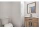 Bathroom featuring modern sink and toilet with a light wood vanity and light neutral walls at 4473 Oberlander Ave, North Las Vegas, NV 89031