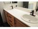 Modern bathroom featuring dual sinks, quartz countertop, and wooden cabinets at 4473 Oberlander Ave, North Las Vegas, NV 89031