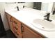 Modern bathroom featuring dual sinks, quartz countertop, and wooden cabinets at 4473 Oberlander Ave, North Las Vegas, NV 89031