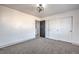 Cozy bedroom with sliding door closet, gray carpet, and contemporary lighting fixture at 4473 Oberlander Ave, North Las Vegas, NV 89031