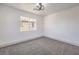 Cozy bedroom featuring gray carpet, a view of the neighborhood, and neutral walls at 4473 Oberlander Ave, North Las Vegas, NV 89031