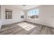 Sunlit bedroom boasting wood-look flooring and large windows providing plenty of natural light, creating a relaxing atmosphere at 4473 Oberlander Ave, North Las Vegas, NV 89031