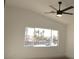 Light-filled bedroom featuring a ceiling fan and a large window showcasing the outside landscape at 4473 Oberlander Ave, North Las Vegas, NV 89031