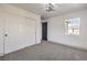 This bedroom features neutral carpet, a window and a closet with sliding doors at 4473 Oberlander Ave, North Las Vegas, NV 89031