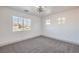 Bright bedroom featuring carpet floors, white walls, contemporary light fixture, and multiple windows at 4473 Oberlander Ave, North Las Vegas, NV 89031