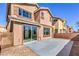 Back exterior view of the house with a slider to the concrete patio and low maintenance yard at 4473 Oberlander Ave, North Las Vegas, NV 89031