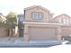 Charming two-story home featuring an attached two-car garage and low maintenance desert landscaping at 4473 Oberlander Ave, North Las Vegas, NV 89031