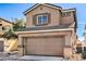 Two story house with a front entrance and a closed two car garage at 4473 Oberlander Ave, North Las Vegas, NV 89031